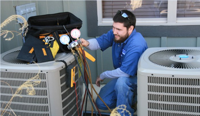 Service technician working on air conditioner