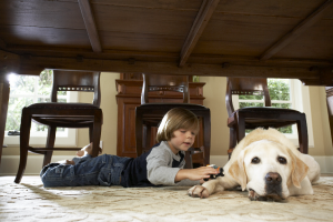 Boy with Dog Laying in well maintained home