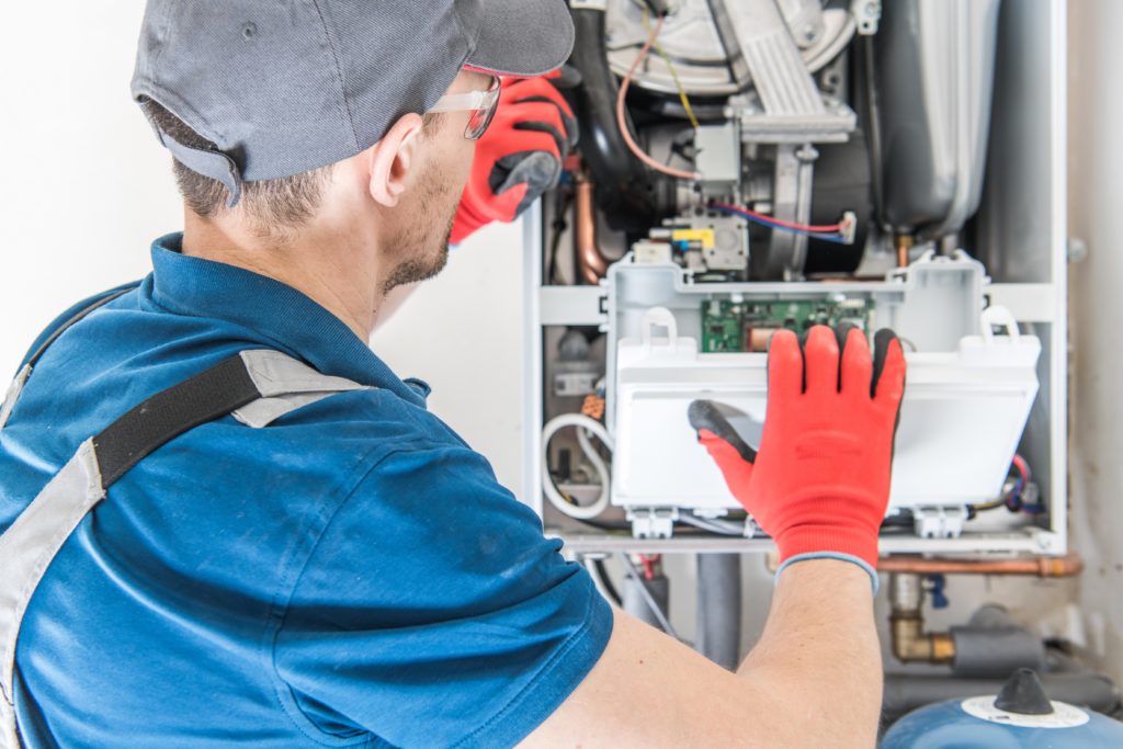 Technician working on a high efficiency furnace