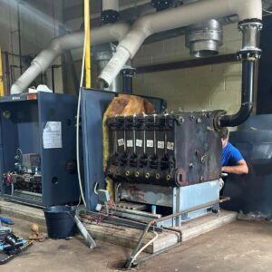 Watkins technician replacing heat exchanger on a commercial steam boiler