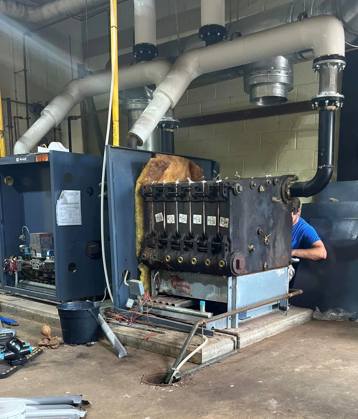 Watkins technician replacing heat exchanger on a commercial steam boiler